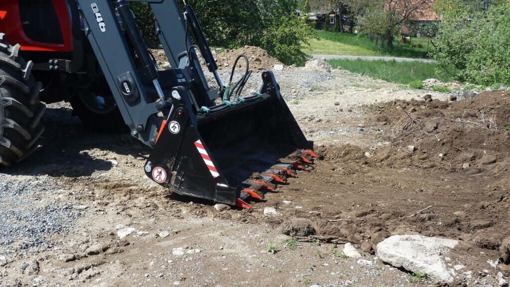 Kovaco 4 in 1 Bucket performing digging tasks on a construction site.