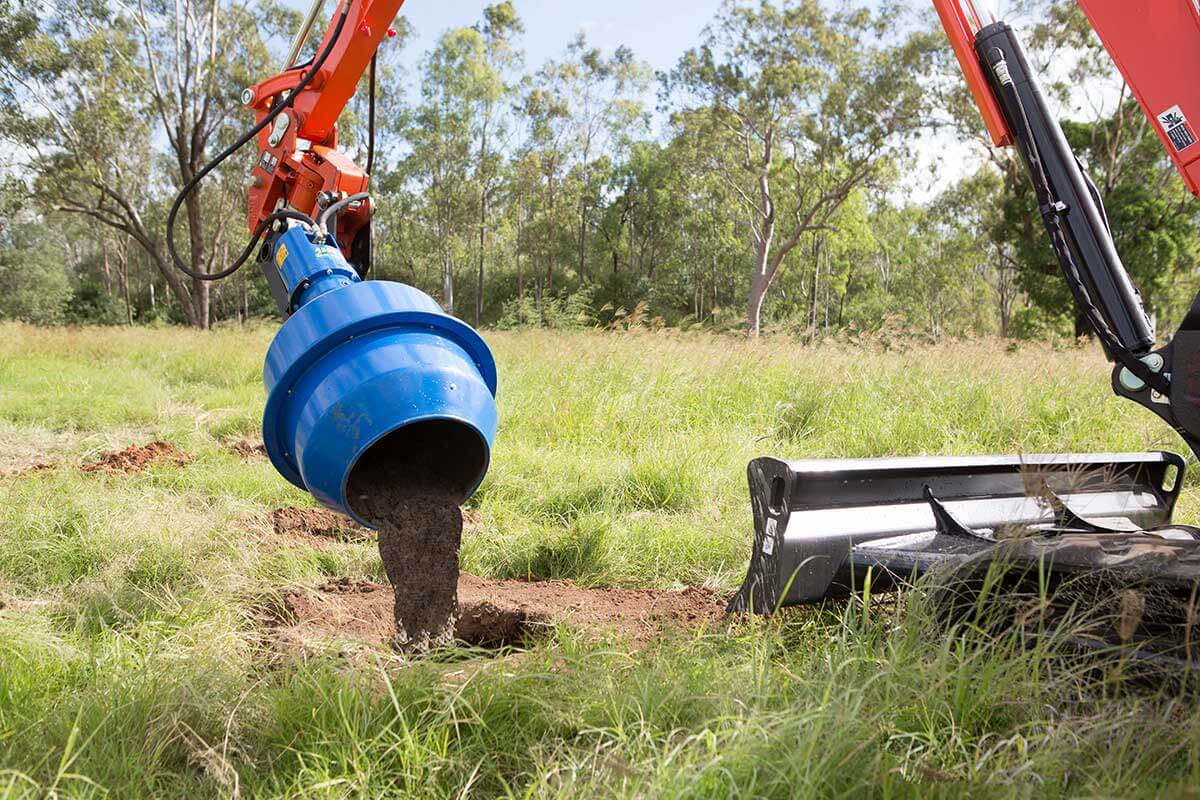 Auger Torque Cement Mixer Bowl for Earth Drills in use on a grassy field, mixing cement for fencing projects.