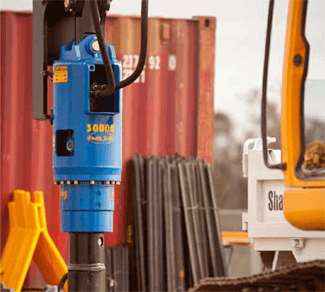 Auger Torque X2500 Earth Drill 1.5-3T attached to excavator for drilling applications.