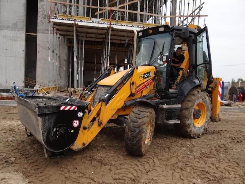 Kovaco - Concrete Mixing Bucket attached to a tractor on a construction site, showcasing its efficiency in mixing concrete.